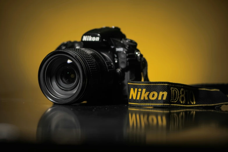nikon dslr is a black digital camera with yellow logo