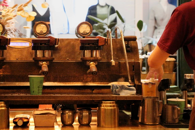 a man standing next to an old fashioned machine