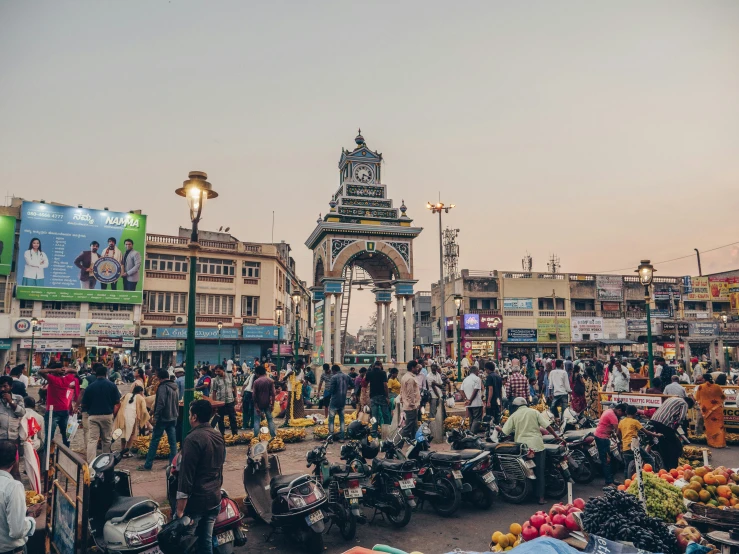 a busy city street with many people near large clock tower