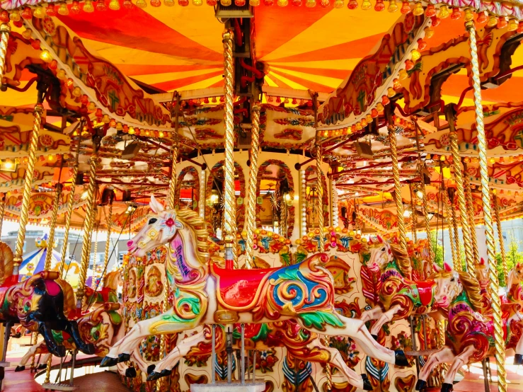 two horses and people on a merry go round