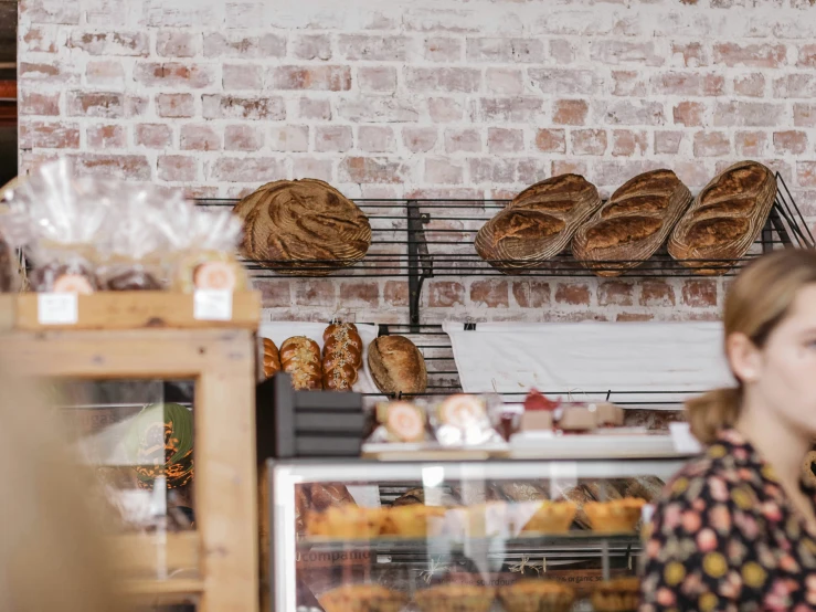 a bakery with baker standing in front of it