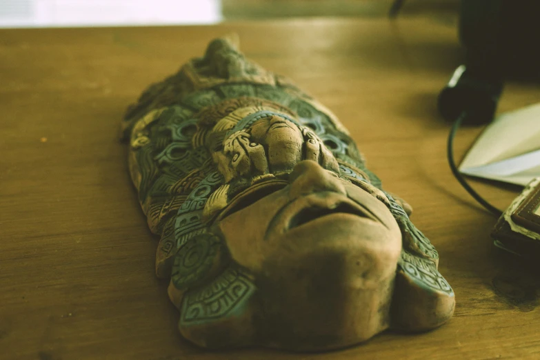 an old cloth covered object on the floor next to a mouse