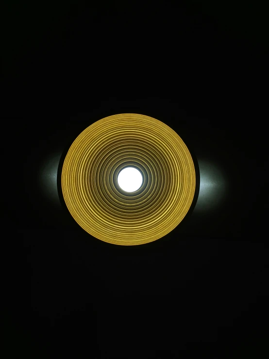 light inside of a black circle in the dark