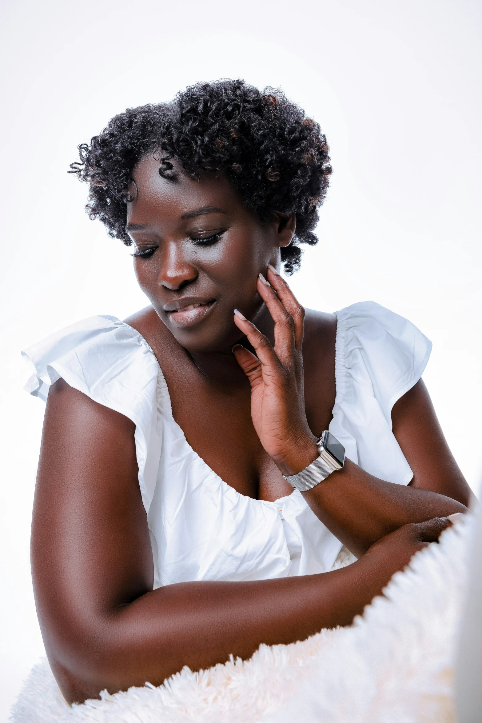 an african woman with short hair looking at her laptop