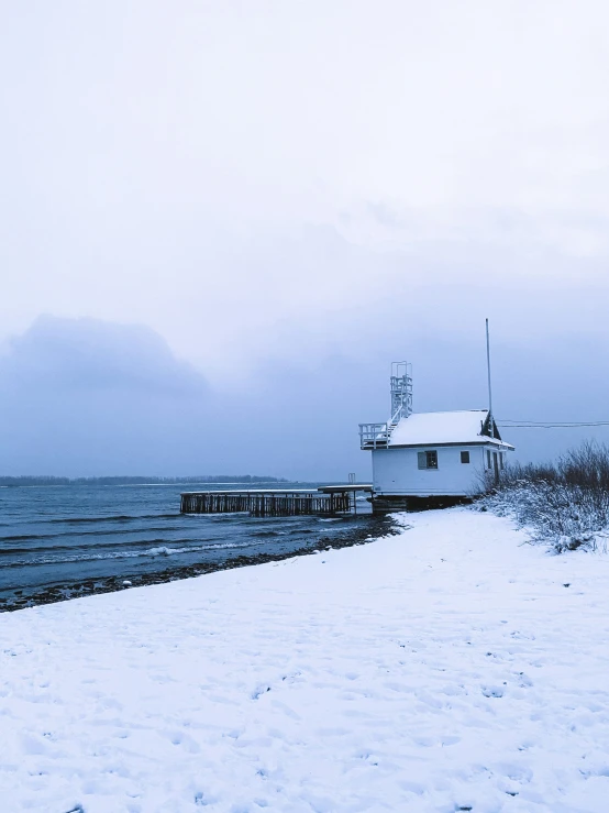 a frozen beach with some small boats in the water