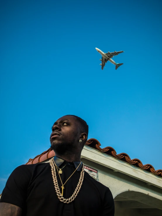 a man standing under a clear blue sky