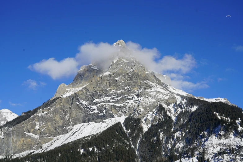 a very tall mountain with many snow on it