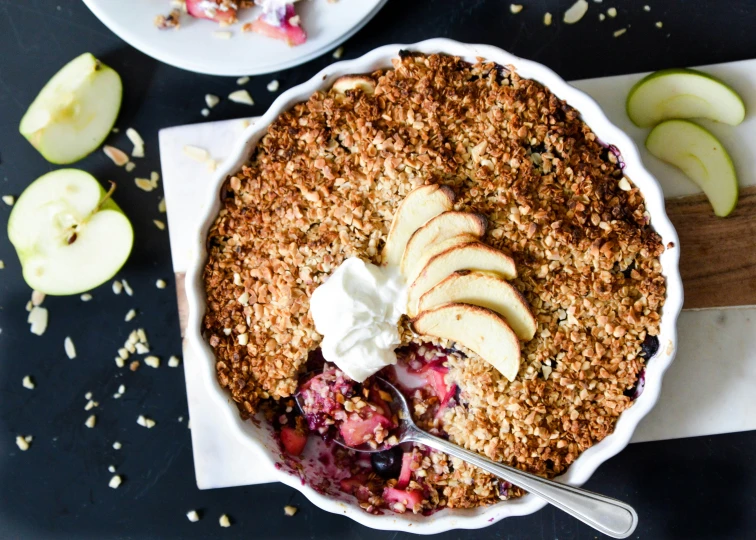 apples, yogurt, and granola are arranged in an apple crisper