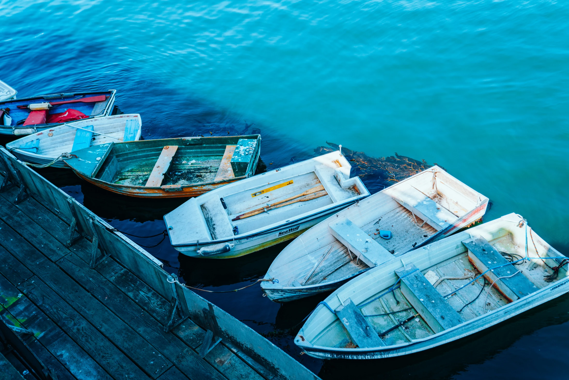 several boats tied up in water at pier