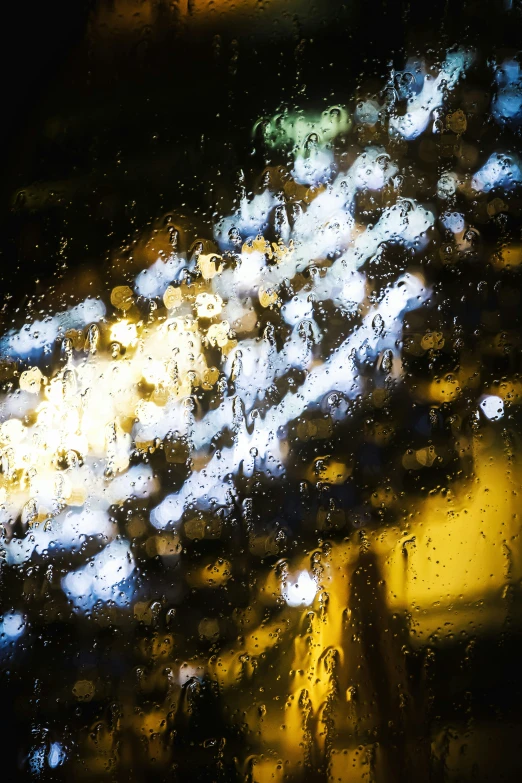 the back of a taxi drives through a rain soaked parking lot