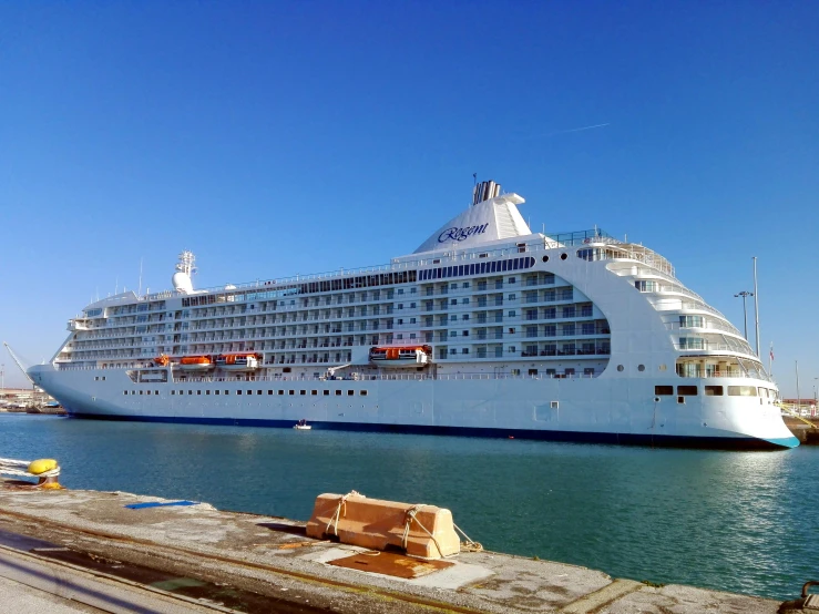 there is a large white cruise ship docked in the water