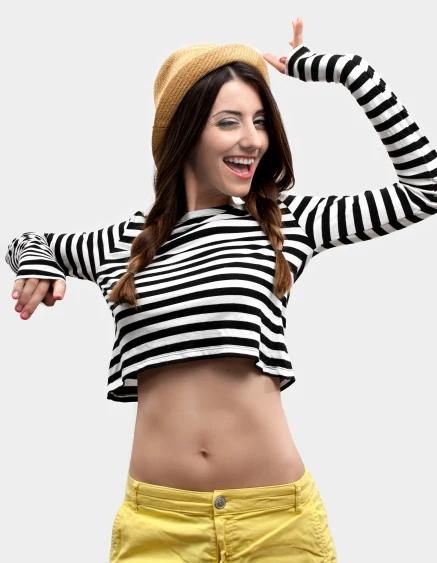 a woman in striped top and yellow shorts posing for a po
