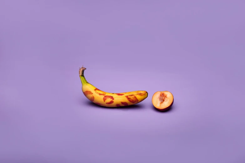 a half a banana next to an unpeeled, cut, ripe one