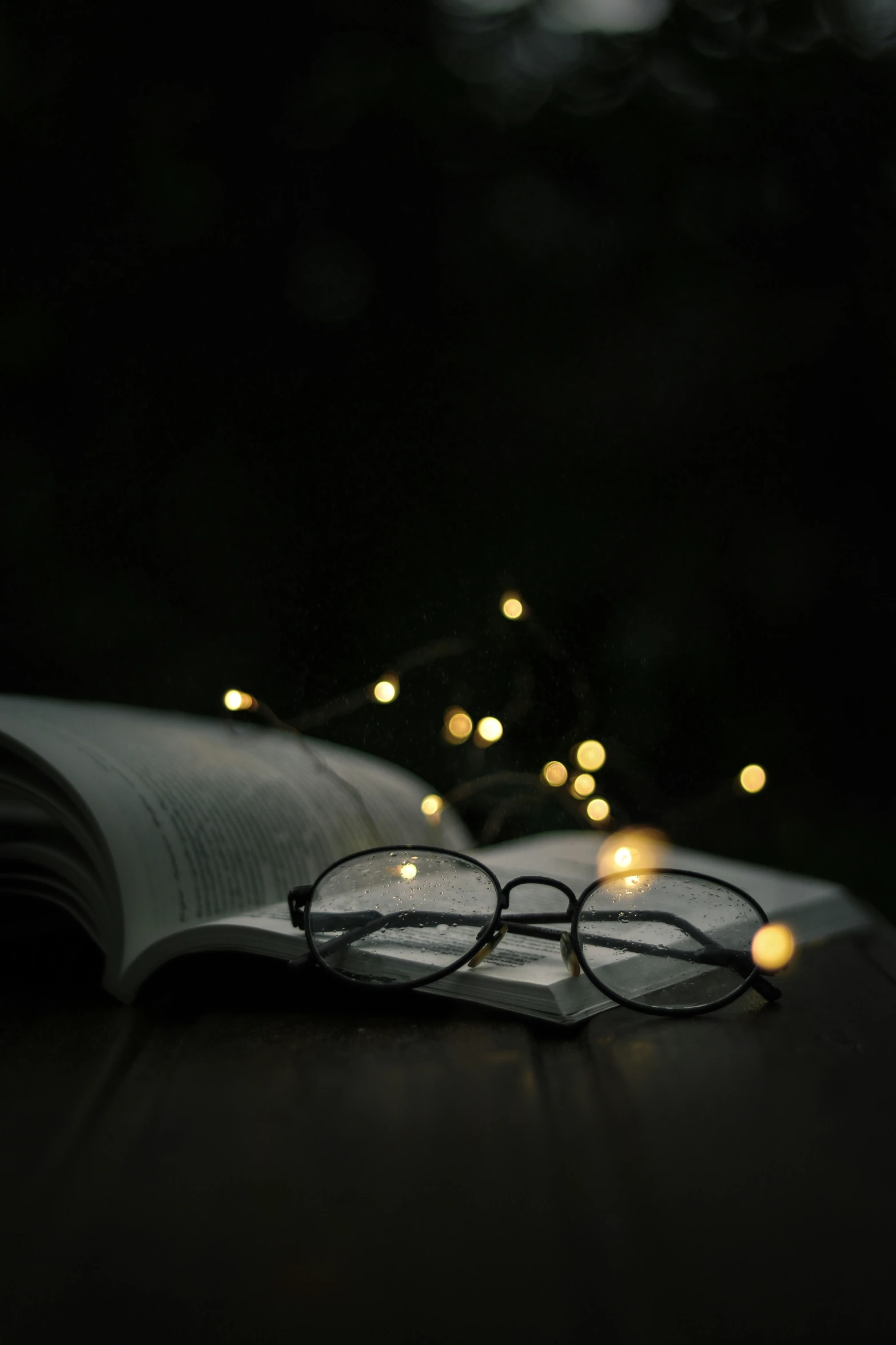 an open book with glasses laying on top of it