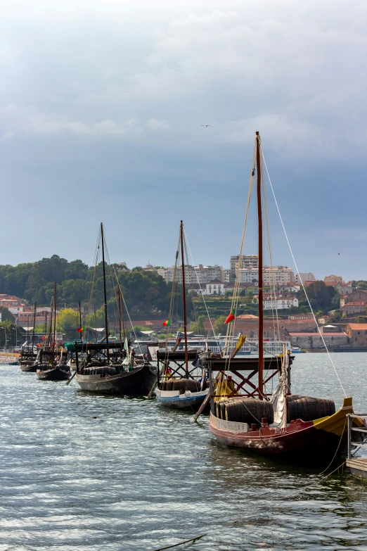 several small boats with sails in the water