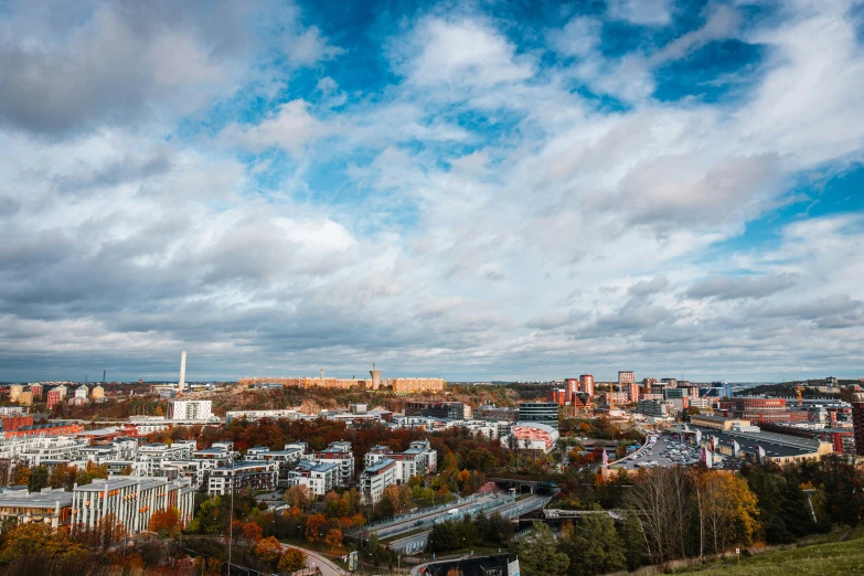 the view from atop a hill looking over a small town