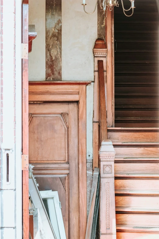 a wood door and staircase inside of an old brick building