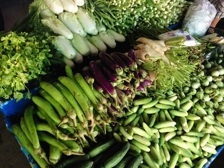 a table with assorted green vegetables on it