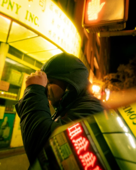 a person standing on a street corner near a building