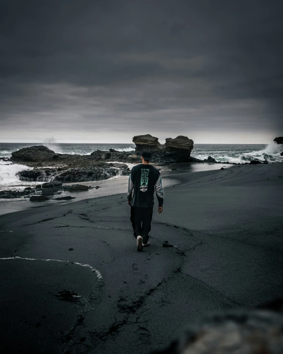 a man walking on the beach in his pajamas