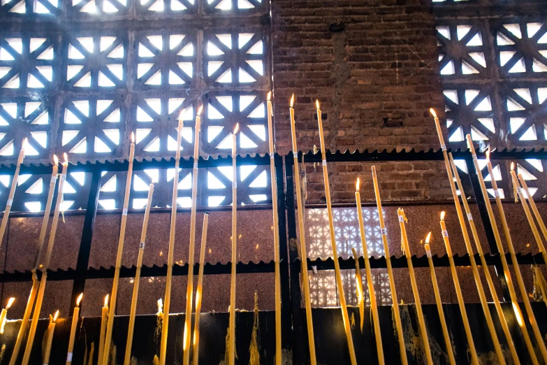 candles in front of a vaulted, arched window