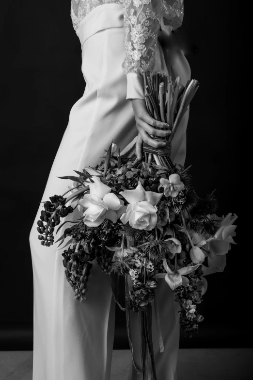 a person holding a bunch of flowers on their arm