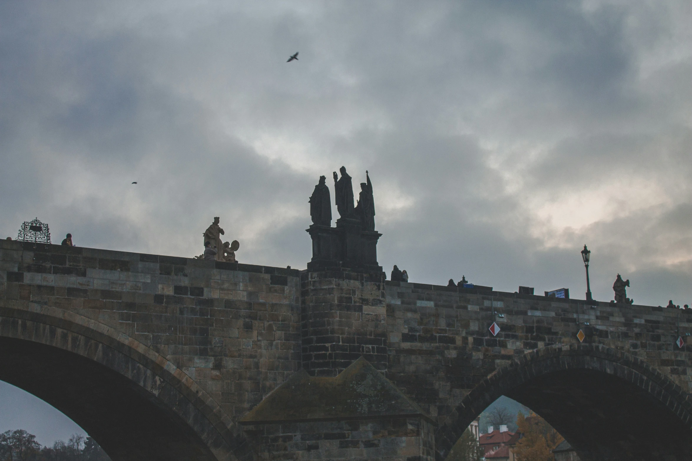 a bird flying over the walls of an old brick structure