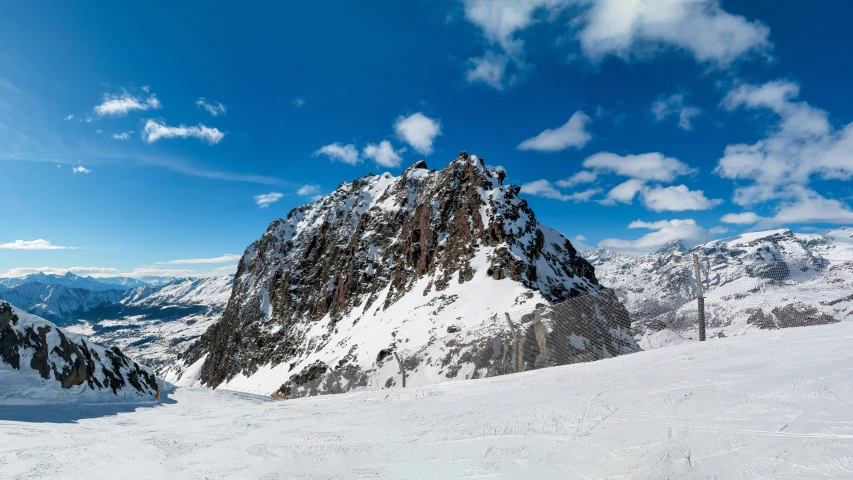 a man riding skis on top of a snow covered slope