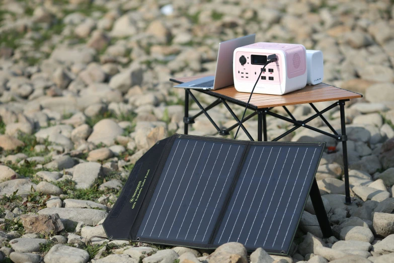 a small portable home on a bench, set atop rocks