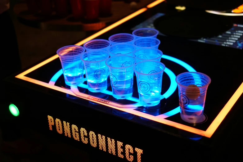 a collection of plastic cups on a glowing plate