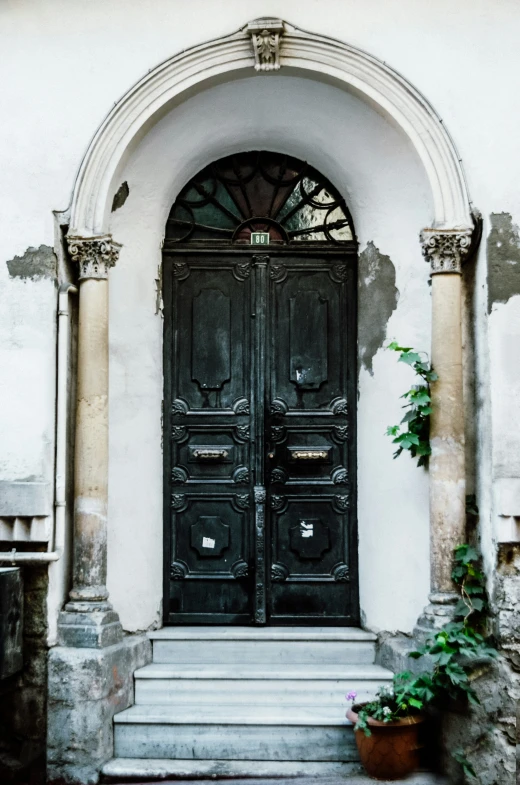 a very old building with a big black door