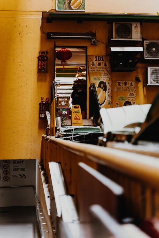 the interior of a restaurant with yellow walls and brown counters