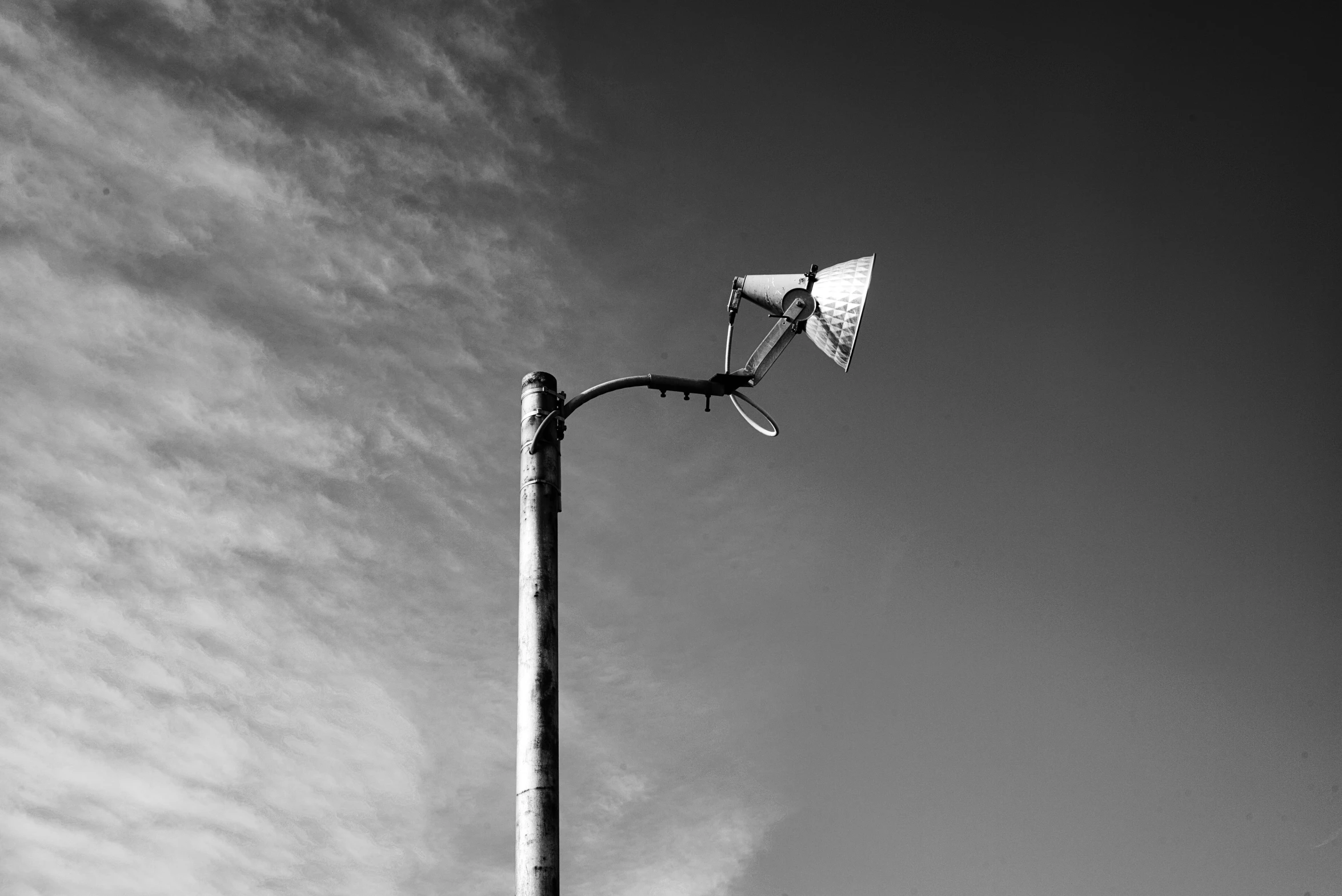 a light that has been turned on the other side of a street pole