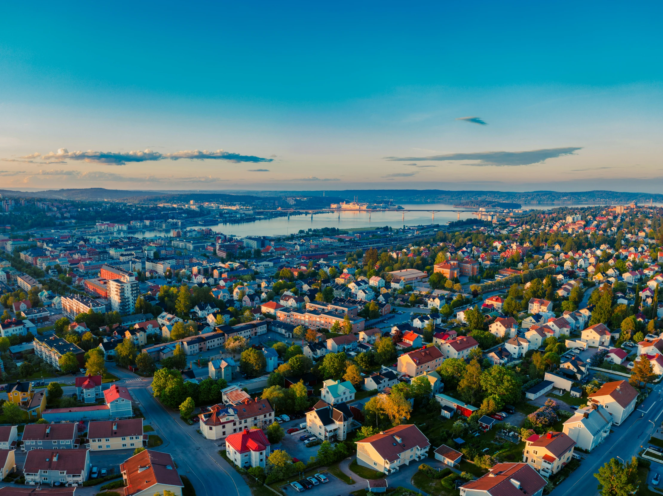 a birds - eye view of a city, the houses are painted red and blue