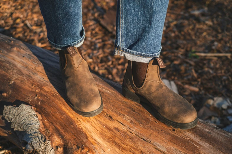 this is a person on a log in jeans