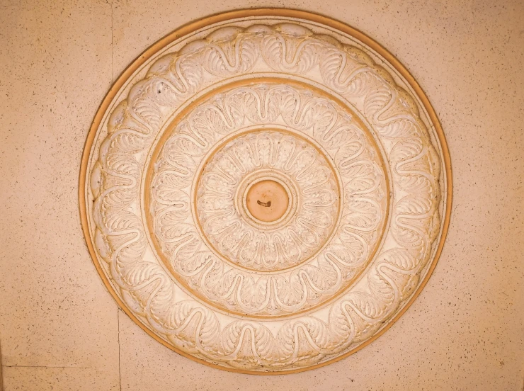 an old, decorative ceiling piece in a building