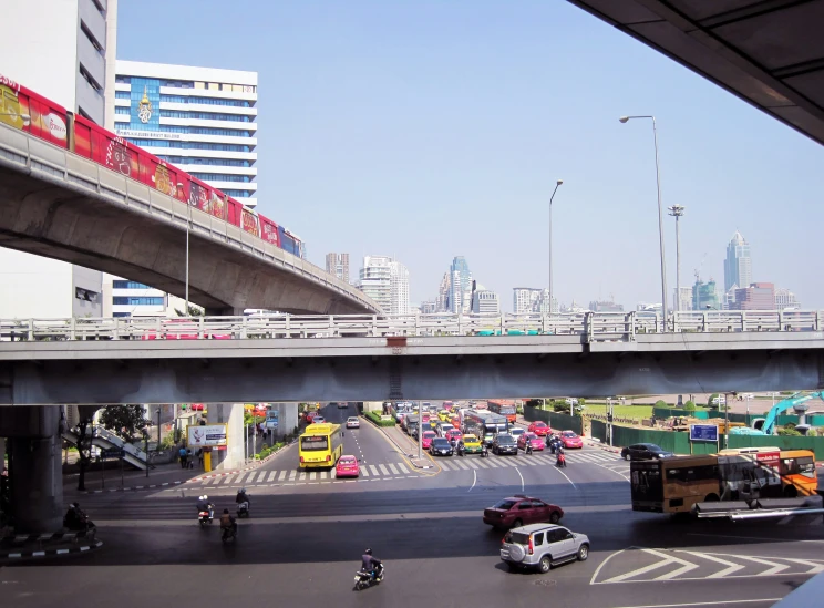 a group of vehicles that are under a bridge