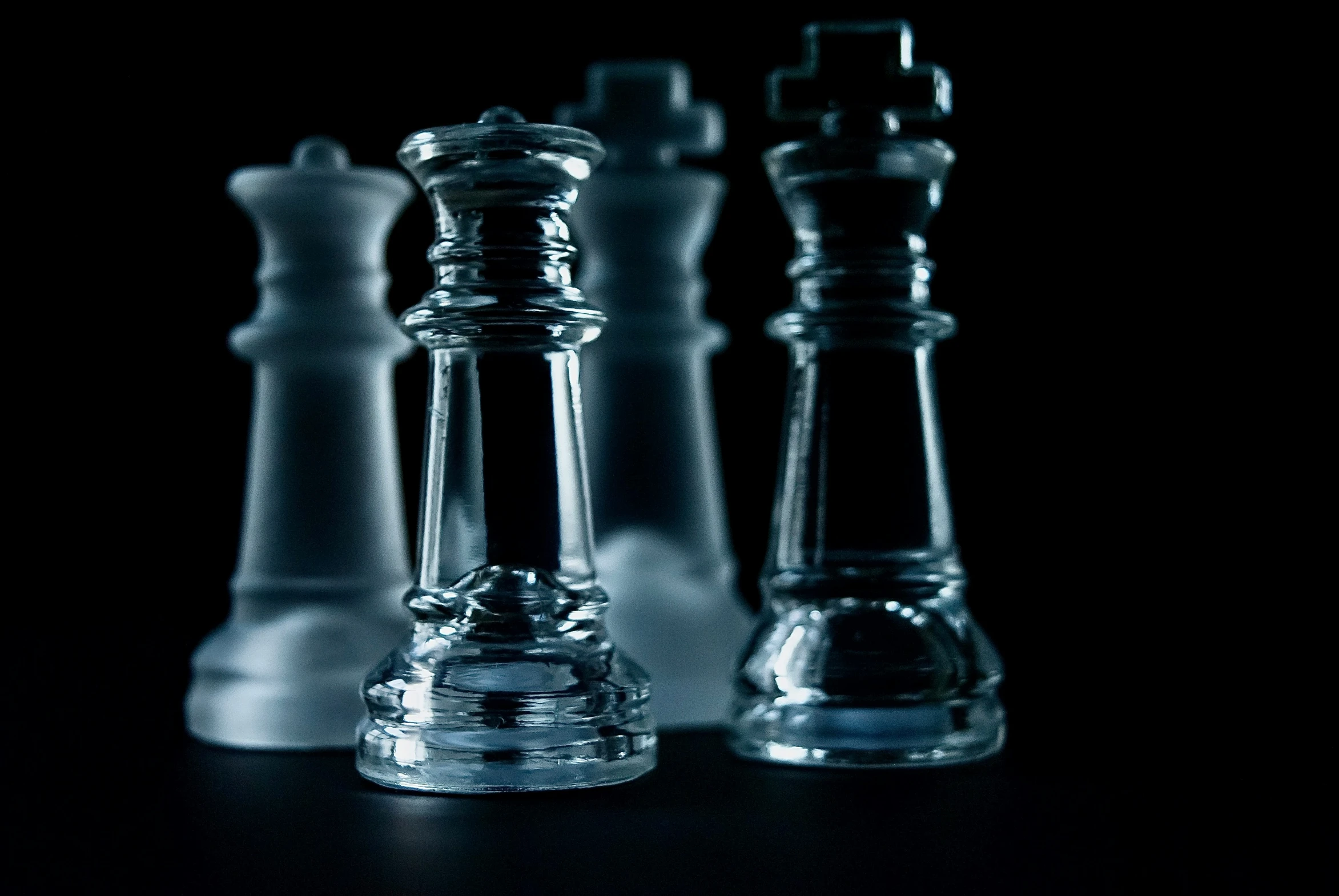 a collection of glass chess pieces on the table