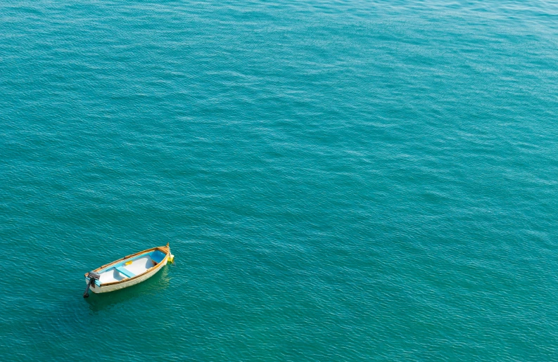 a small boat is shown floating in the water