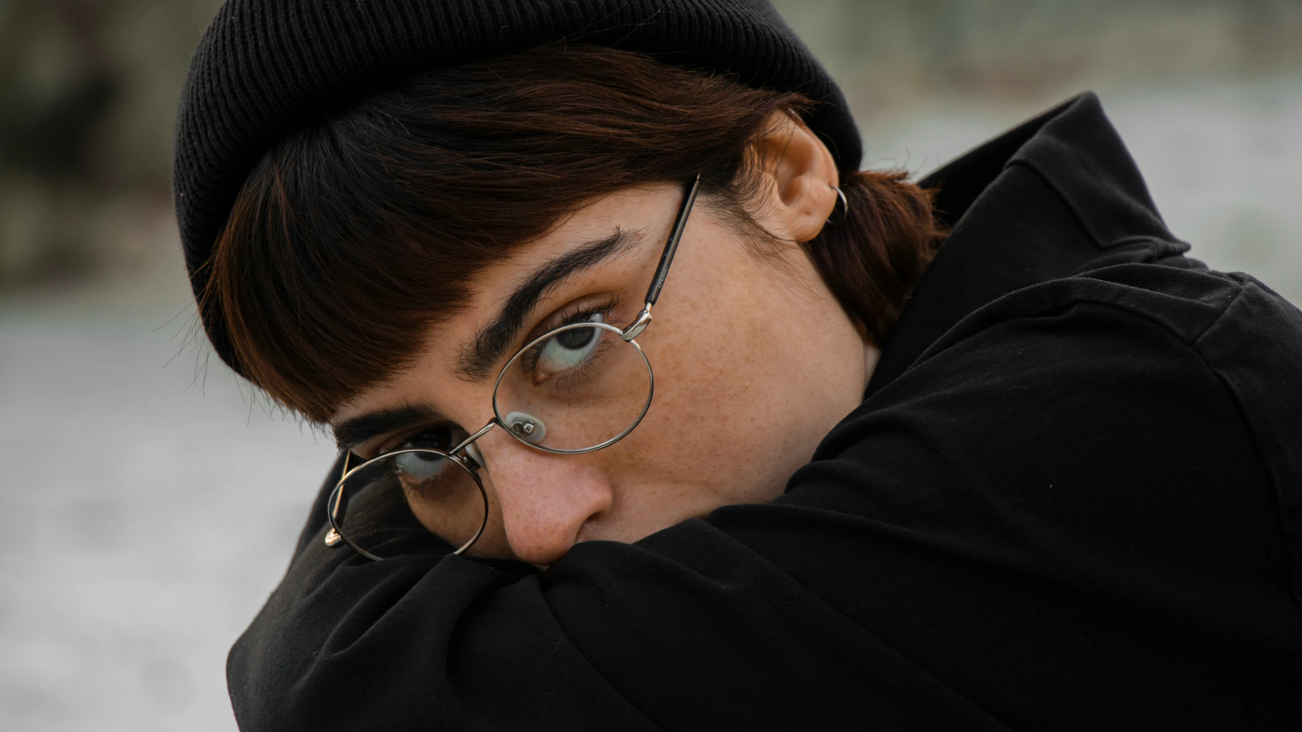 a man holding his head near his face