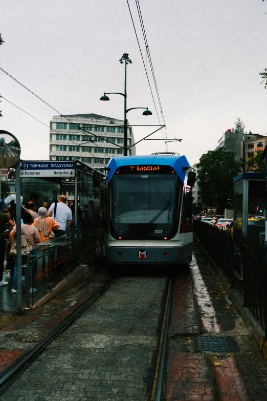 a blue and white train traveling down train tracks