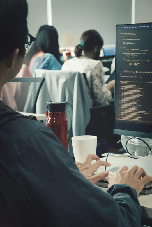 a man is at the computer working on his paper