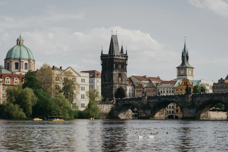 a castle like building with clocks on top near water