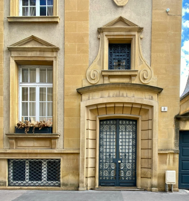 a beige building has a clock on it