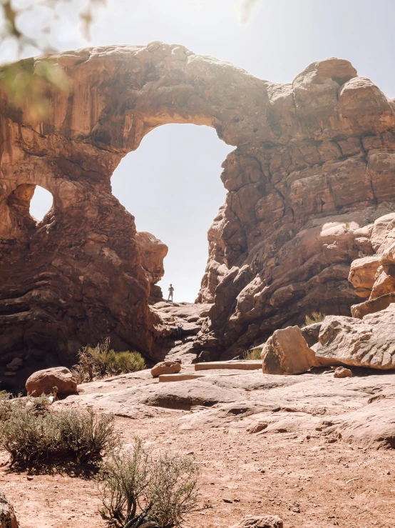 some rocks and a building with an arch