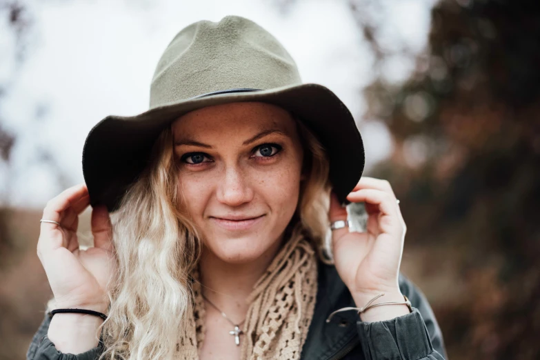 a girl in a hat and scarf wearing a coat