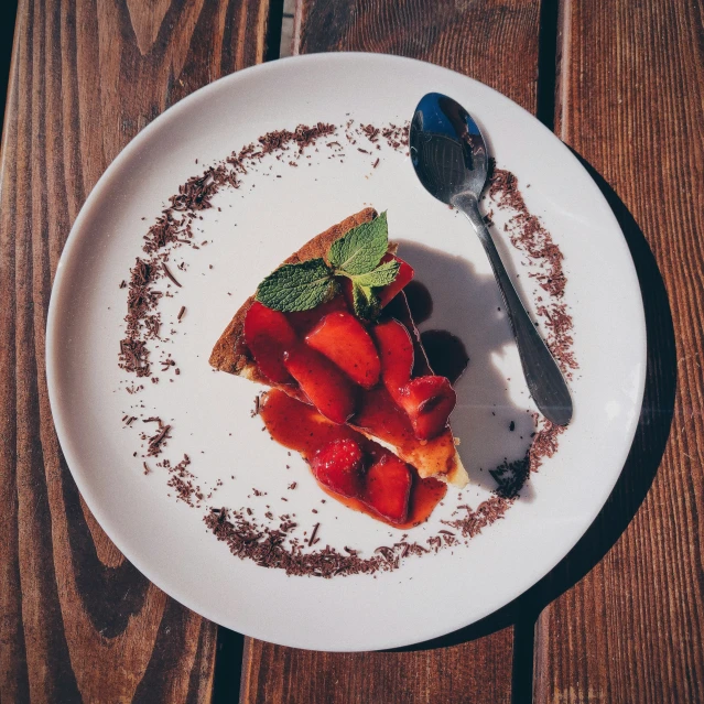 a plate with some sliced strawberries on it