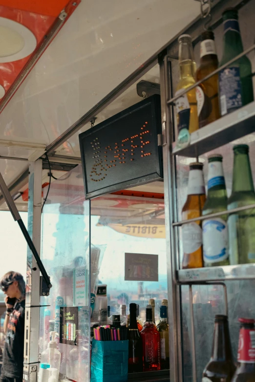 a group of soda bottles behind a glass window