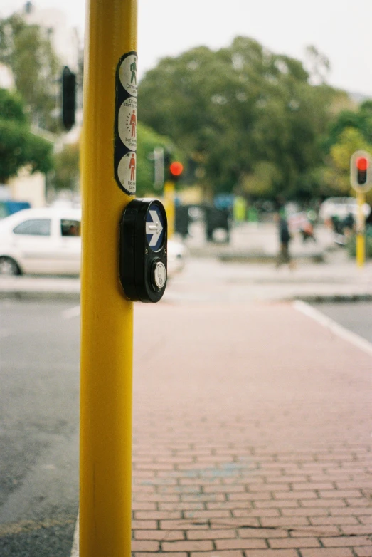 a couple of yellow poles sitting on the side of a road