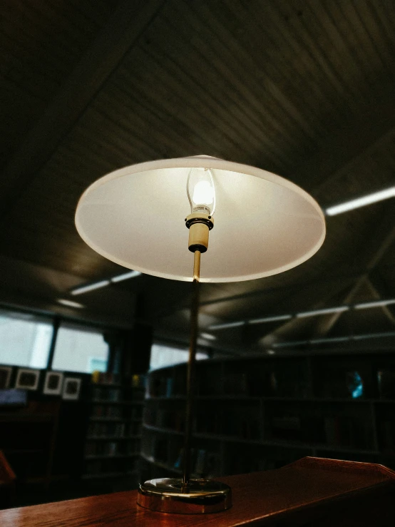 an old fashioned table lamp on top of a wooden table